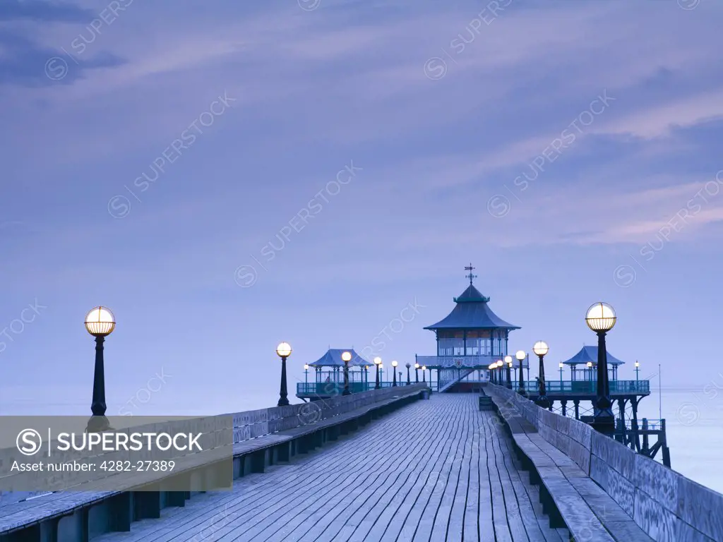 England, Somerset, Clevedon. Twilight view along the boardwalk towards the end of Clevedon Pier, the only fully intact, Grade 1 listed pier in the country.
