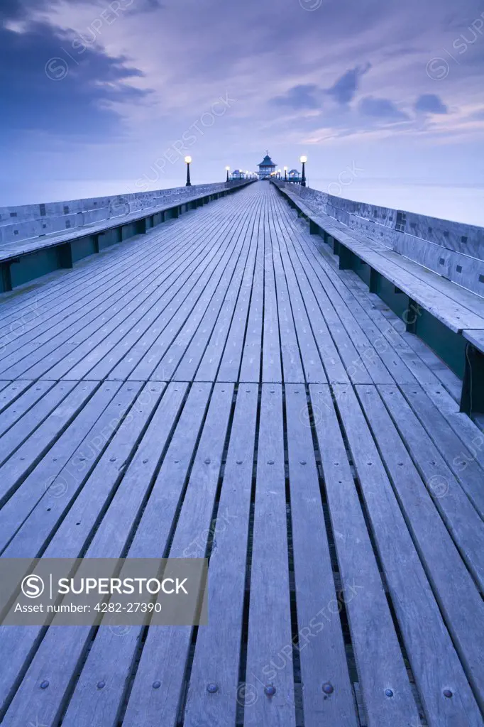 England, Somerset, Clevedon. Twilight view along the boardwalk towards the end of Clevedon Pier, the only fully intact, Grade 1 listed pier in the country.