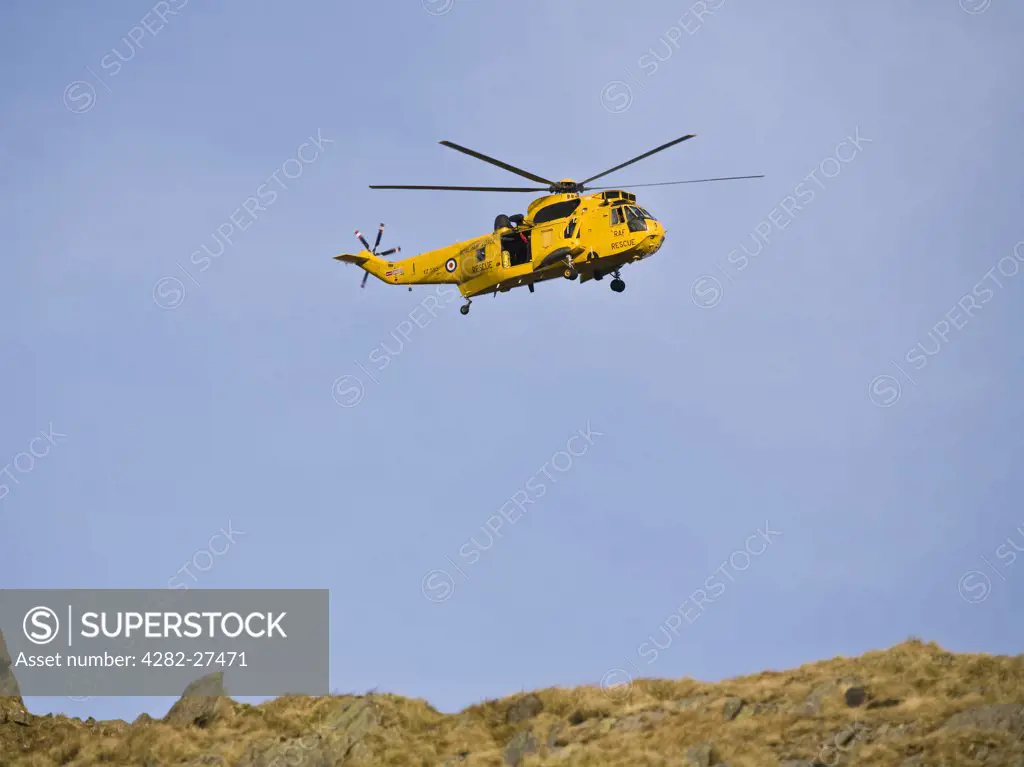 Wales, Gwynedd, Snowdonia. A RAF Rescue Sea King helicopter hovering in Snowdonia National Park.