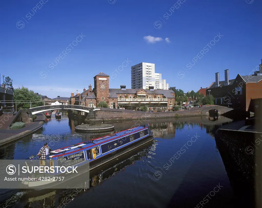 England, West Midlands, Birmingham. A long boat on a canal in Birmingham.