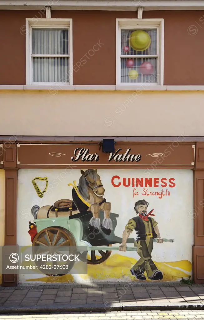 Northern Ireland, County Londonderry, Londonderry. An old Guinness advertising mural.