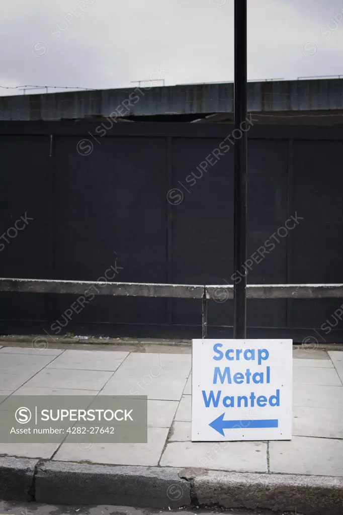 England, London, Hackney. Scrap Metal Wanted sign leaning against a lamp post.