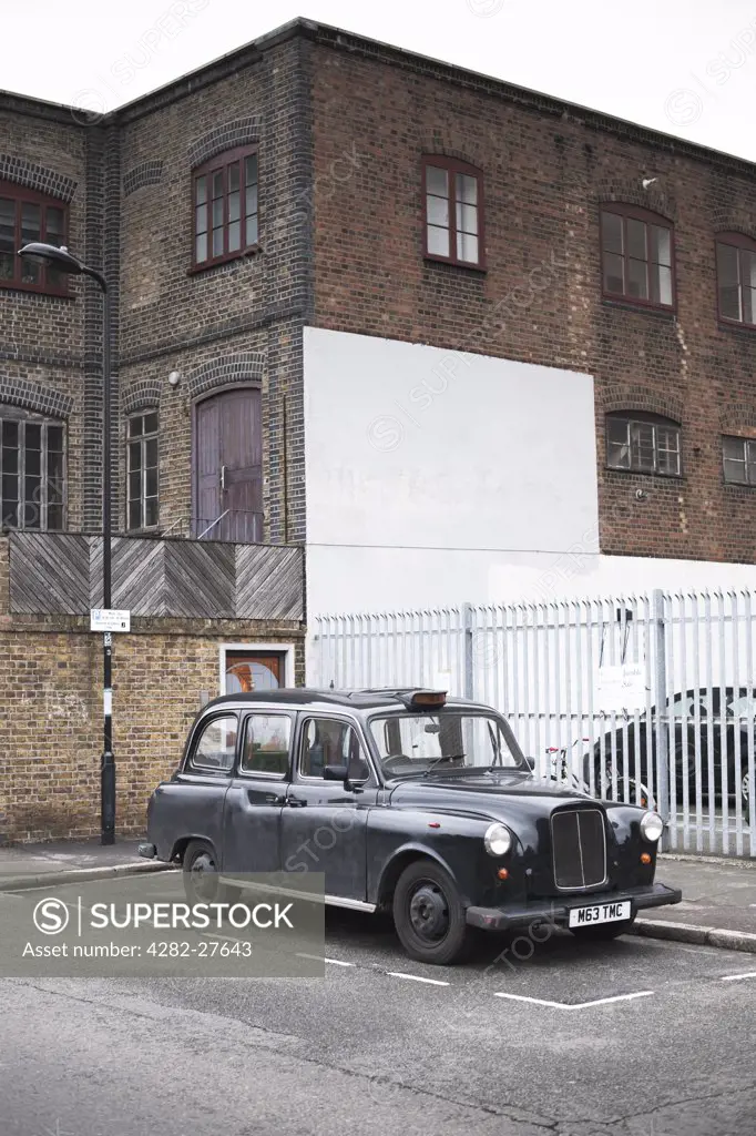 England, London, Hackney. A black London taxi in a parking bay.