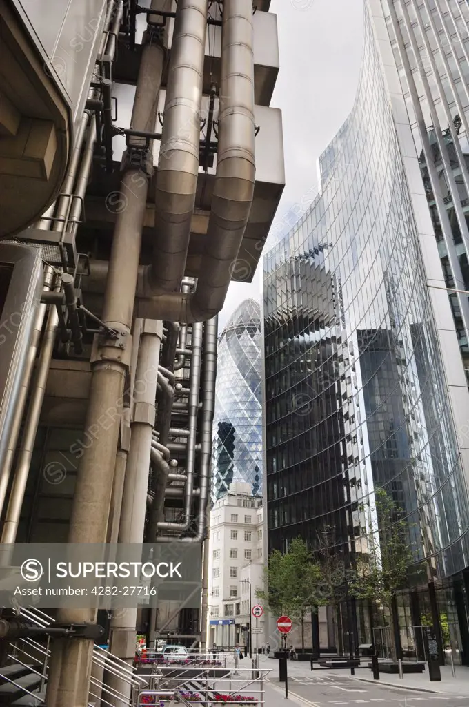 England, London, City of London. View past the Lloyds Building towards The Gherkin (30 St Mary Axe and the Swiss Re Building) in the City of London.