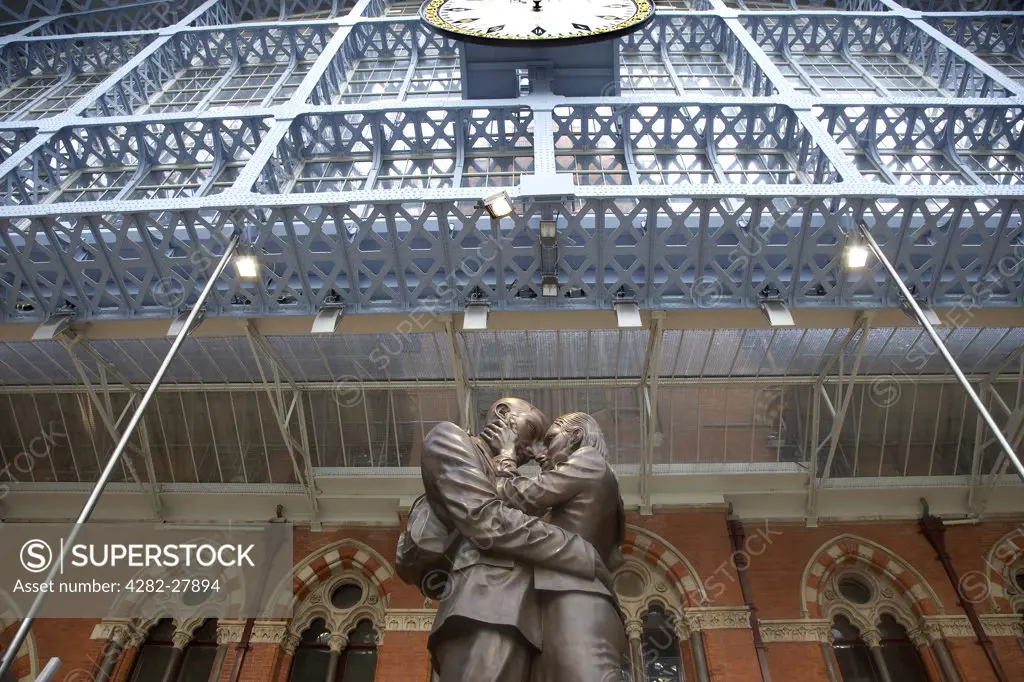 England, London, St Pancras. Interior of St Pancras station with bronze statue by Paul Day.