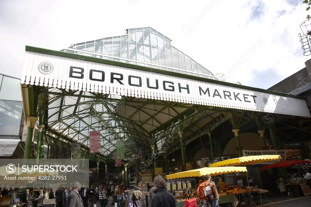 England, London, Borough Market. Looking up at the glass roof and sign over the entrance to Borough Market.