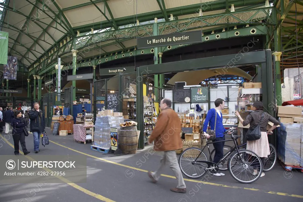 England, London, Borough Market. An interior view of stalls and customers at Borough Market.