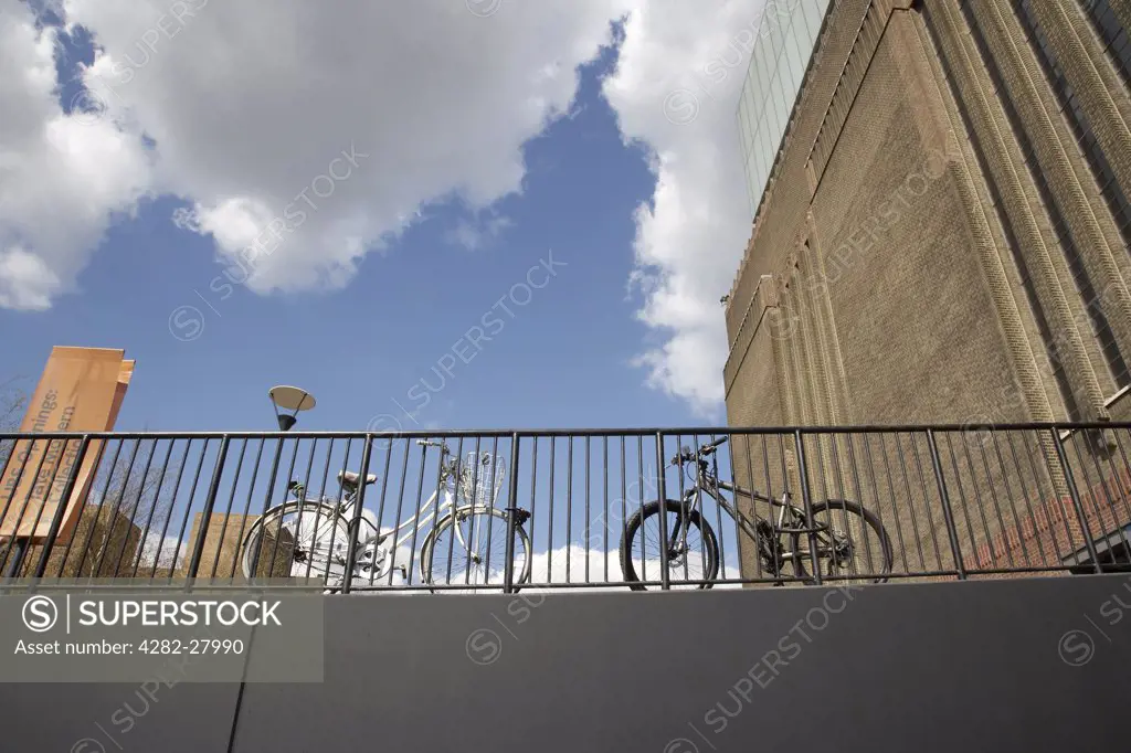 England, London, South Bank. Bikes attached to railings outside the main entrance to the Tate Modern.