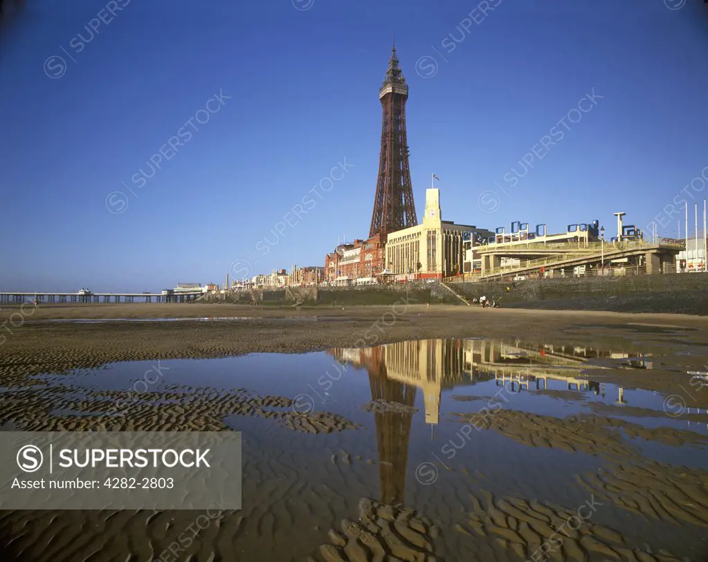 England, Lancashire, Blackpool. Blackpool Tower reflections on the beach.