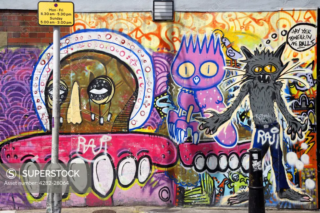England, London, Brick Lane. An array of graffiti characters on a wall in Brick Lane.