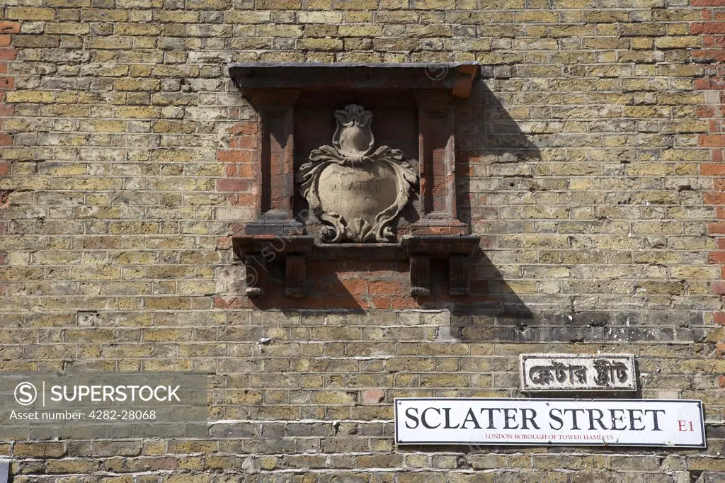 England, London, Brick Lane. A view of a street sign on a wall just off Brick Lane.
