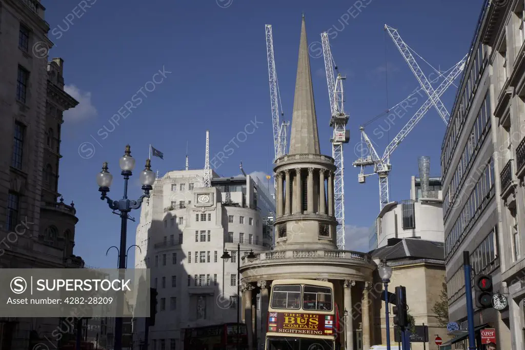 England, London, Marylebone. A view of All Souls Church with cranes rising high in the background.