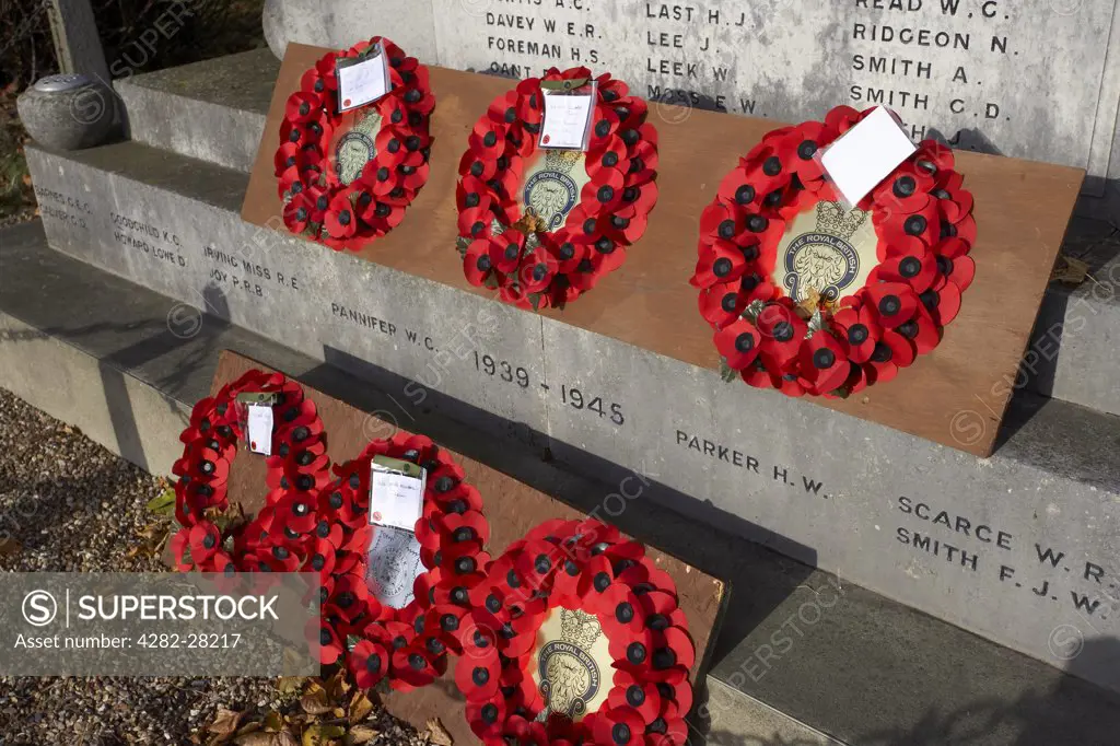 England, Suffolk, Aldeburgh. Poppy wreaths with messages laid upon a War Memorial in Aldeburgh.