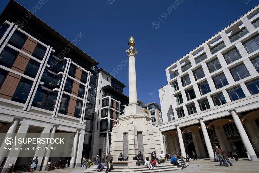 England, London, St Paul's. A view of Paternoster Square and the Monument to the Great Fire of London in the City of London.