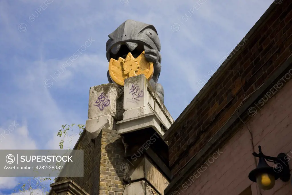 England, London, Great Eastern Street. Post Modernist money munching street sculpture on top of a building in Great Eastern Street.