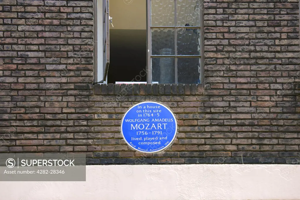 England, London, West End. A blue English Heritage plaque on the wall of a house stating that Mozart lived, played and composed on this site 1764-5.