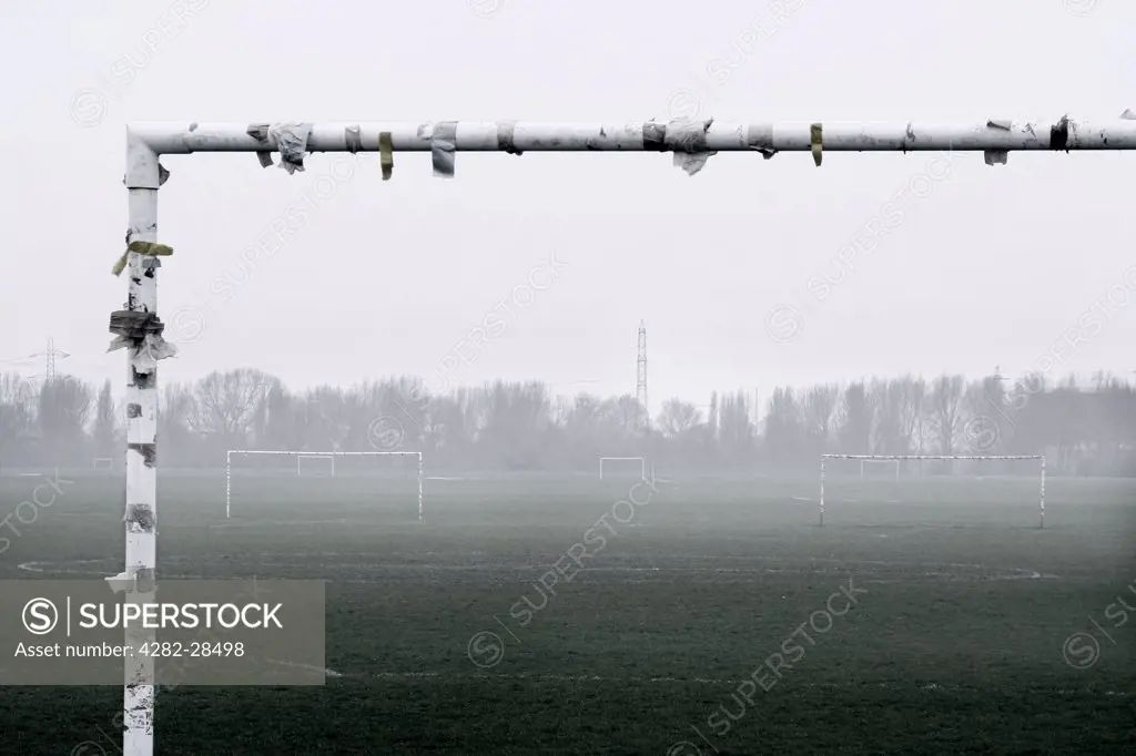 England, London, London. Football pitches on a misty day. The Football Association states that an estimated 7 million adults and 5 million children play amateur football across the UK.