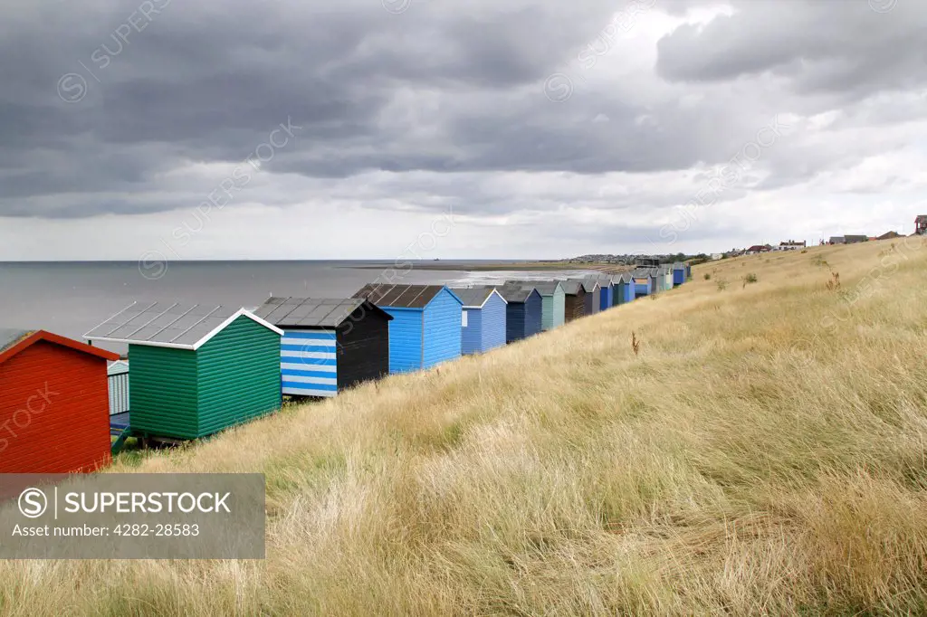 England, Kent, Whitstable. Beach huts along the seafront at Whitstable.