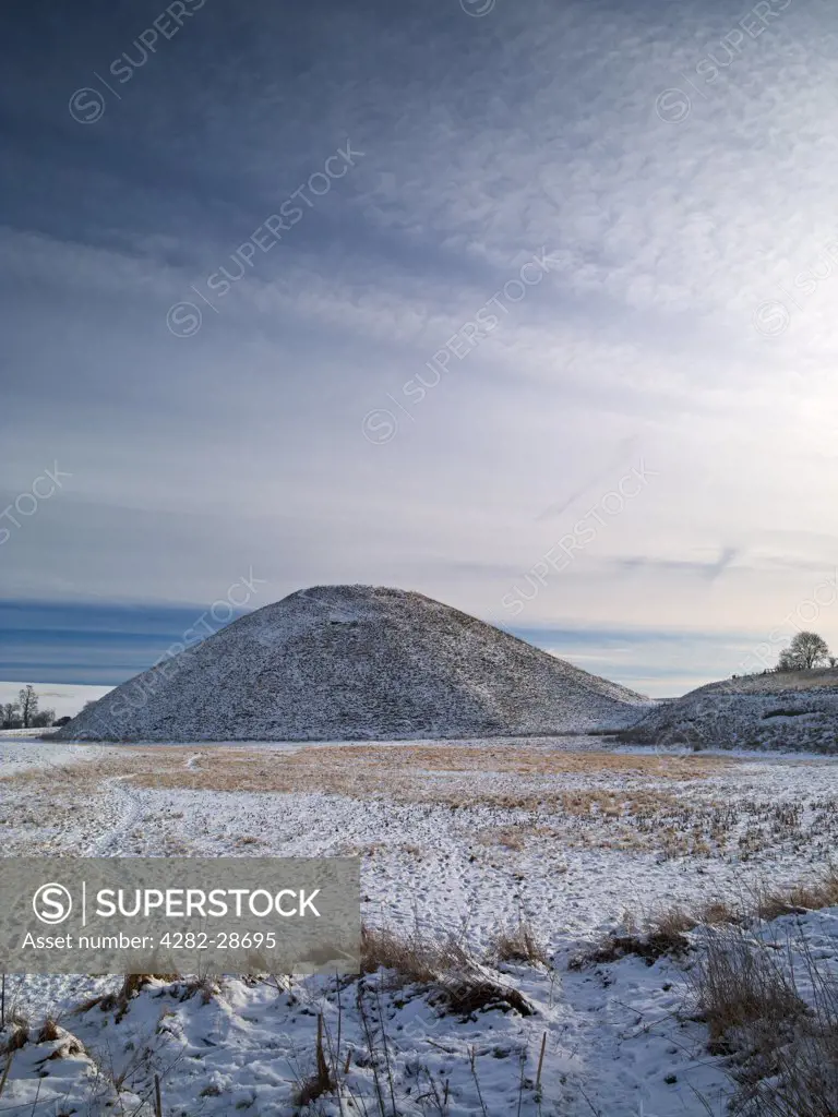 England, Wiltshire, near Avebury. Silbury Hill, an ancient megalithic monument in Wiltshire, covered in a layer of snow and frost.