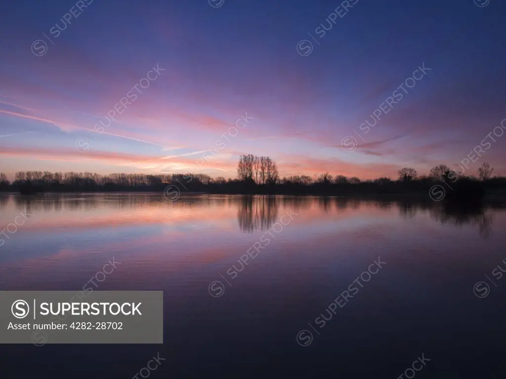 England, Wiltshire, near Malmesbury. Dawn over Mallard Lake at Lower More Farm. The lake is designated as a Site of Special Scientific Interest as it contains rare stoneworts.