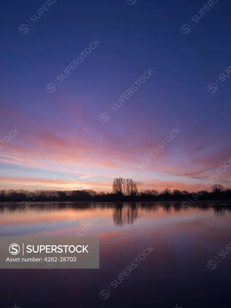 England, Wiltshire, near Malmesbury. Dawn over Mallard Lake at Lower More Farm. The lake is designated as a Site of Special Scientific Interest as it contains rare stoneworts.
