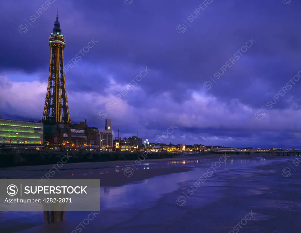 England, Lancashire, Blackpool. Reflections on the beach from Blackpool Illuminations.