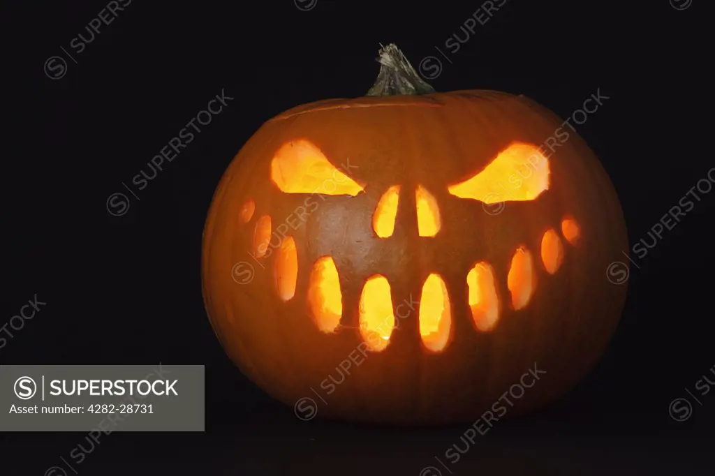 A face carved into a pumpkin for Halloween.