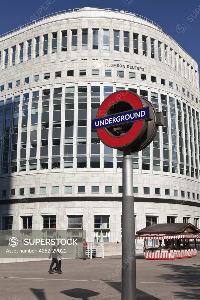 England, London, Canary Wharf. London Underground sign in Canary Wharf opposite the Thomson Reuters building.