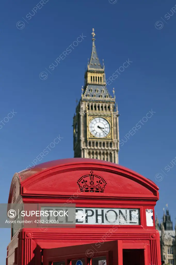England, London, Westminster. A red telephone box with Big Ben in the background.