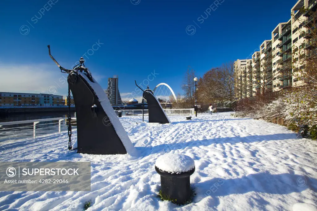 Scotland, City of Glasgow, Glasgow. View over the Clyde Quayside redevelopment area covered in snow towards Glasgow's Clyde Arc bridge, more commonly known as the Squinty Bridge.