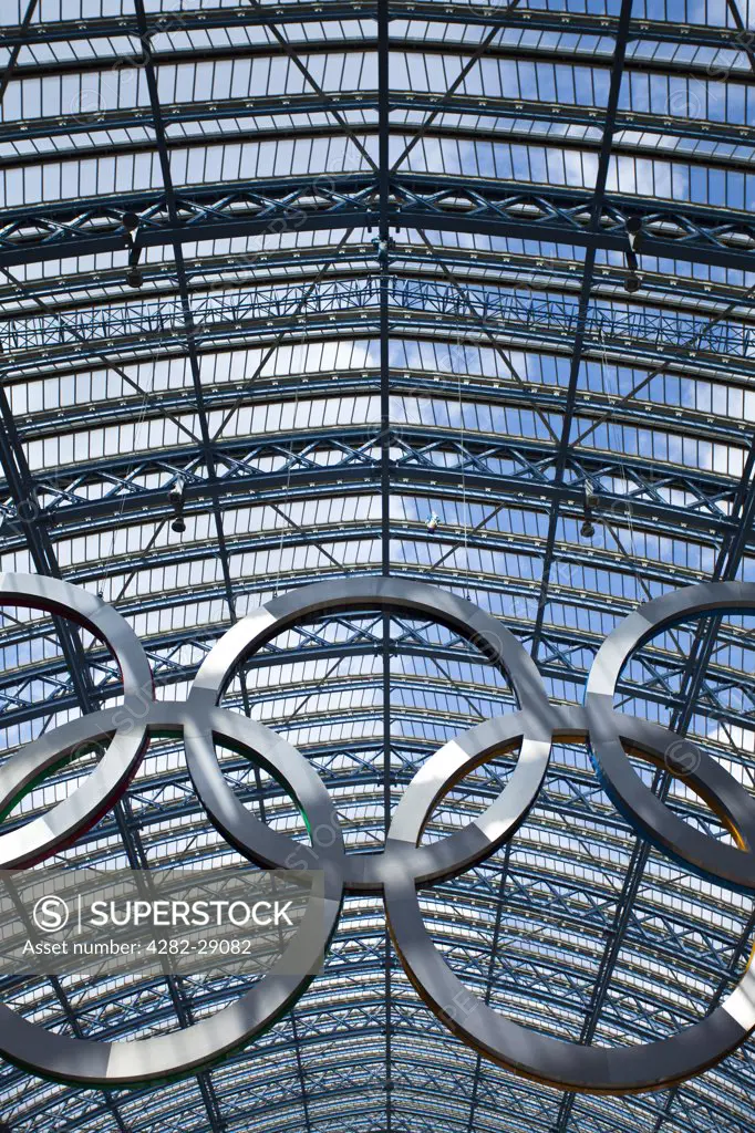 England, London, St Pancras. A giant set of Olympic rings suspended in St Pancras International Station to welcome visitors to London, host city of the 2012 Olympic Games.