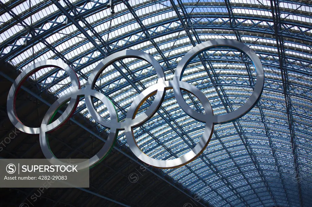 England, London, St Pancras. A giant set of Olympic rings suspended in St Pancras International Station to welcome visitors to London, host city of the 2012 Olympic Games.