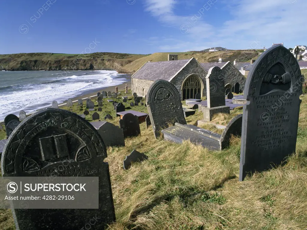 Wales, Gwynedd, Aberdaron. St Hywyn's double-aisled, late Norman church is situated at the end of the Lleyn peninsula, near the embarkation point for pilgrims to Bardsey Island. It's seaside graveyard contains many finely carved slate headstones from the 1800s.