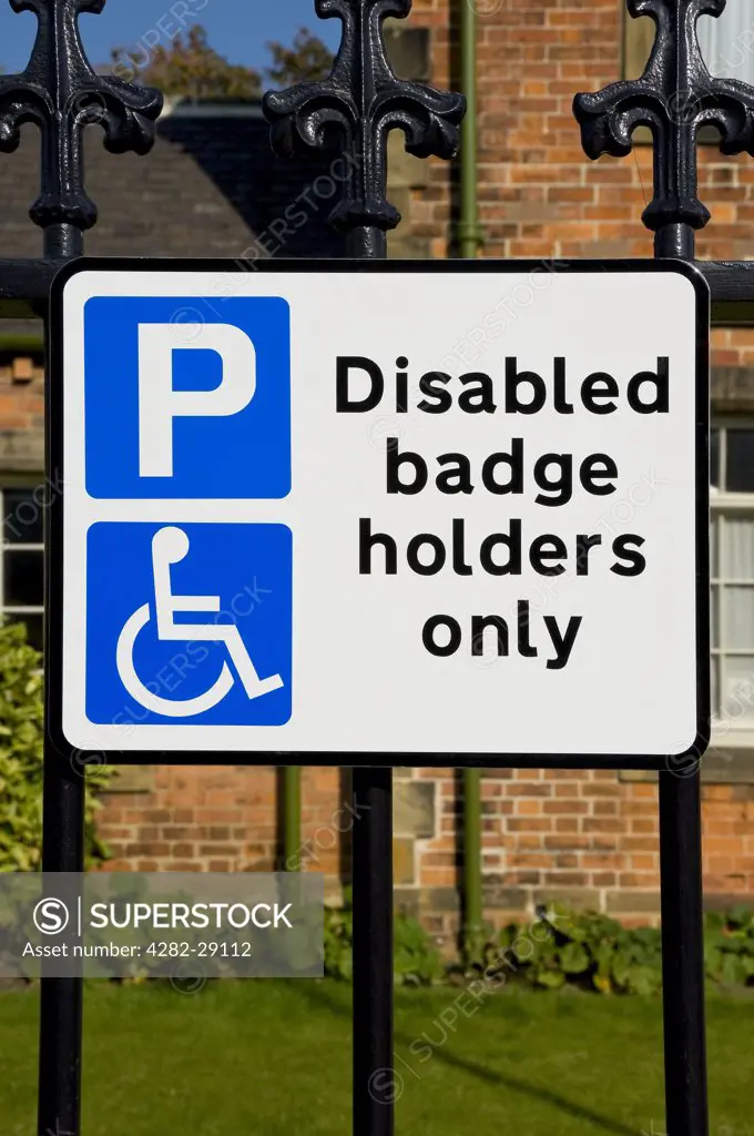 England, North Yorkshire, Ripon. Parking sign displaying 'Disabled badge holders only', on street.