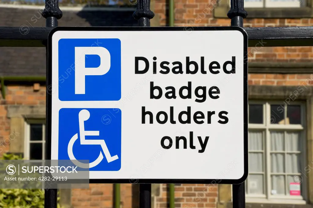 England, North Yorkshire, Ripon. Parking sign displaying 'Disabled badge holders only', on street.
