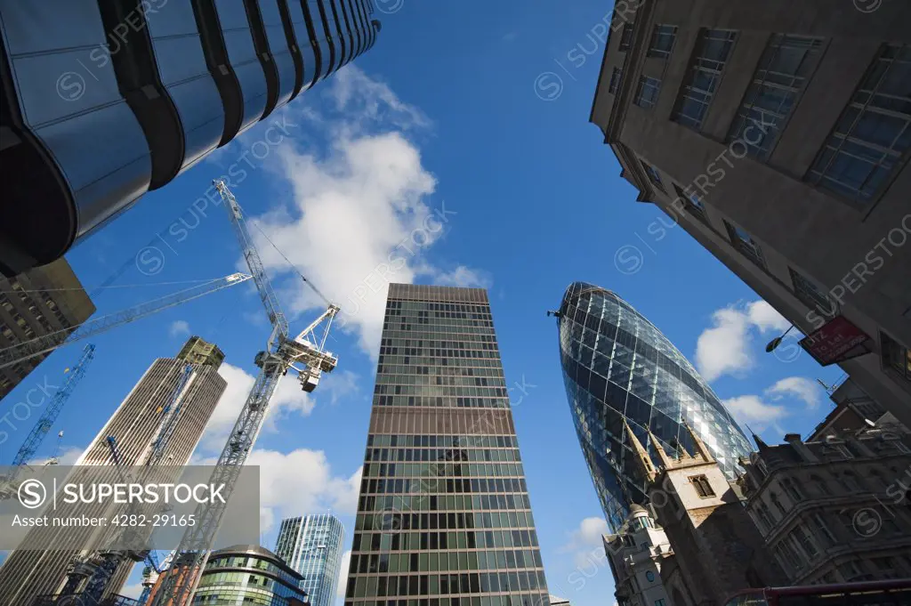 England, London, City of London. High rise office buildings and construction cranes in the City of London, home to some of the most expensive real estate in the world.