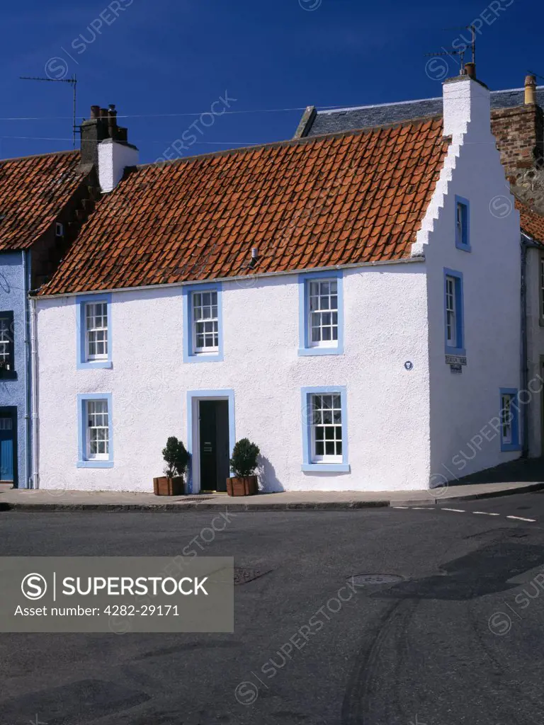 Scotland, Fife, St Monans. This house on West Shore facing the harbour is typical of the distinctive vernacular style seen in the fishing villages of the area, with harled walls and red pantiled roof with stepped gables known as crow steps.