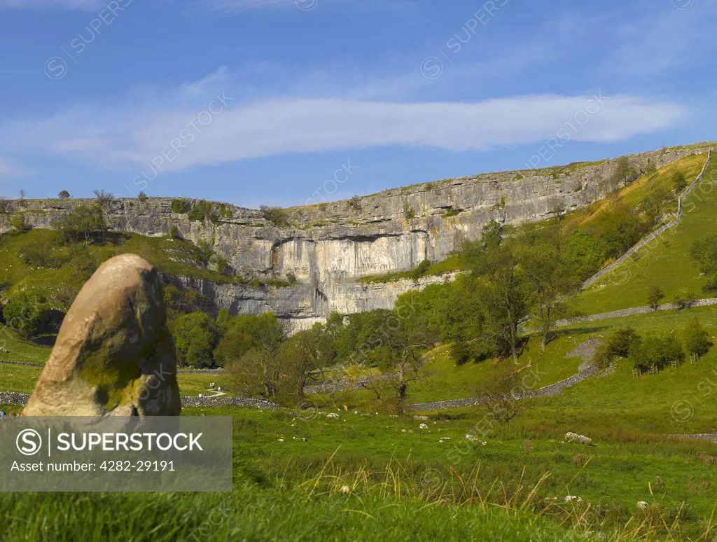 England, North Yorkshire, Malham Cove. People exploring Malham Cove, an 80 metre high limestone crag formed after the last ice age.