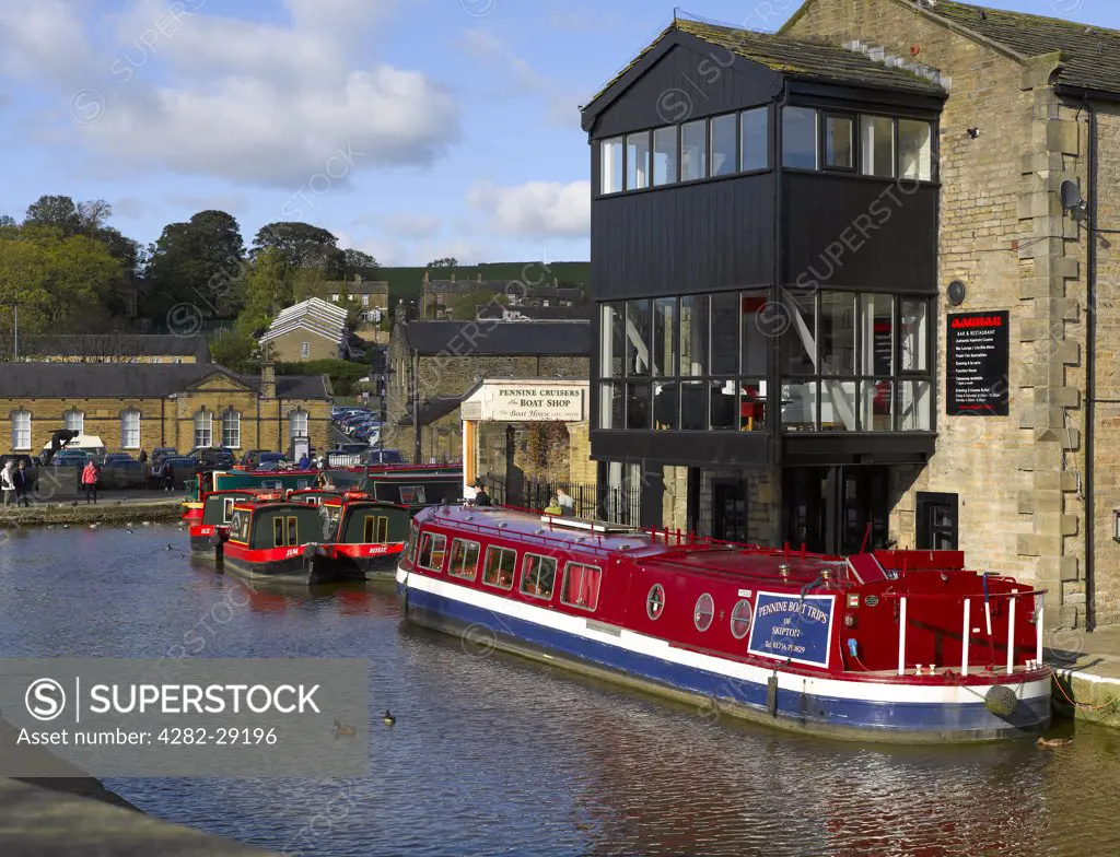 England, North Yorkshire, Skipton. Narrow boats moored on the Leeds and Liverpool canal at Skipton.