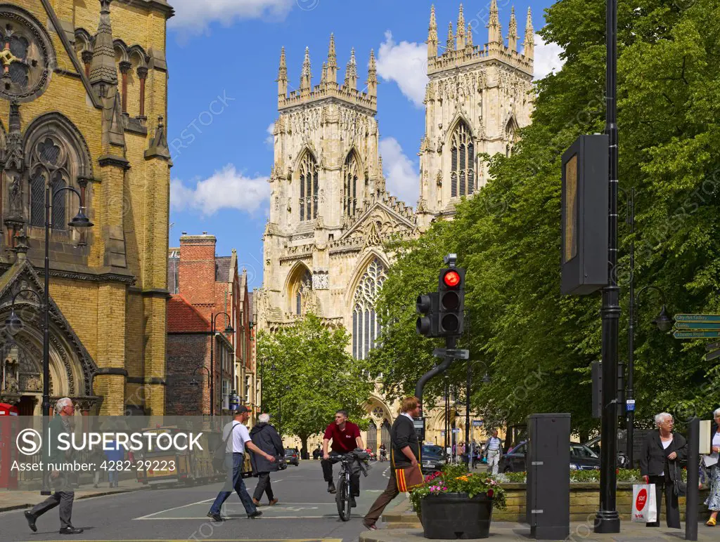 England, North Yorkshire, York. The West Front of York Minster and St Wilfrids church in Duncombe Place.