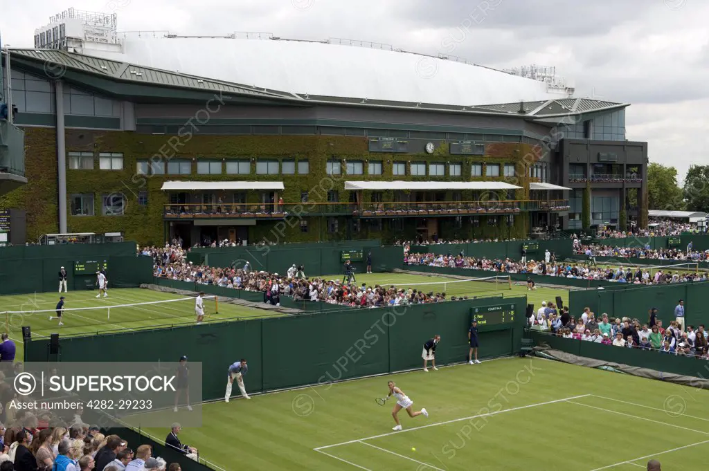England, London, Wimbledon. Matches on the outside courts with Centre Court in the background at the 2011 Wimbledon Tennis Championships.