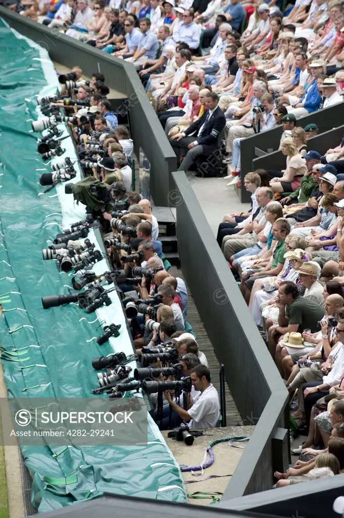 England, London, Wimbledon. Photographers at work on Centre Court during the 2011 Wimbledon Tennis Championships.