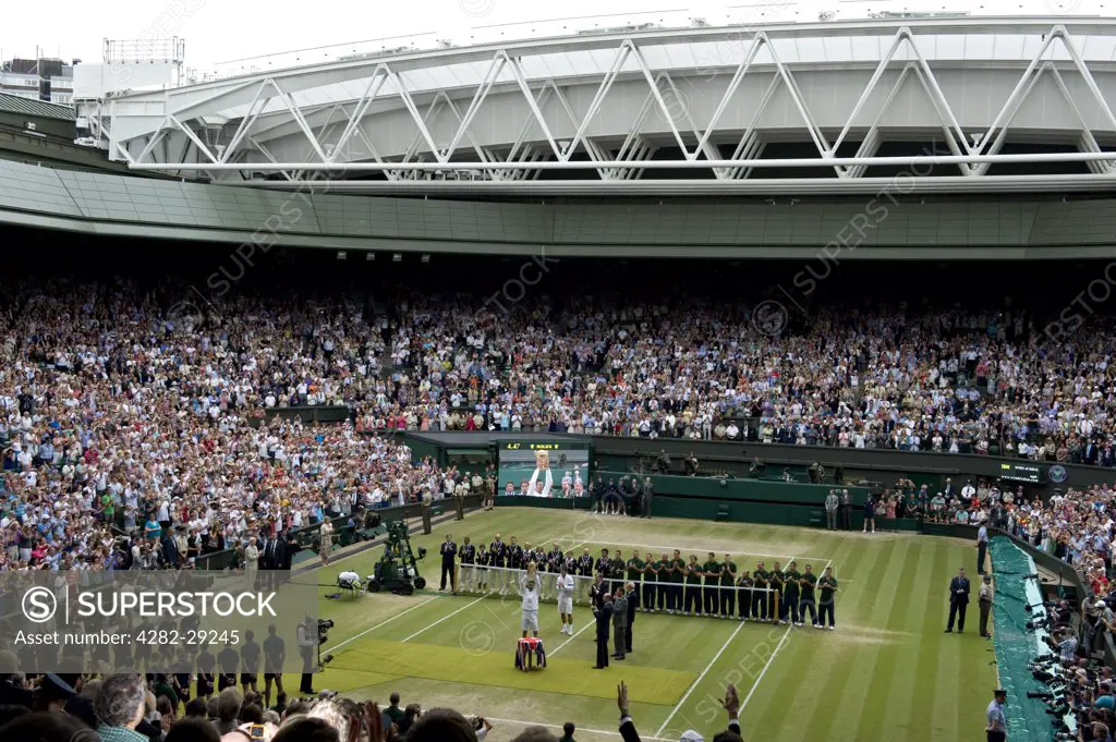 England, London, Wimbledon. Novak Djokovic holds the Men's singles trophy aloft during the prize presentation on Centre Court after winning the Men's Singles Final at the 2011 Wimbledon Tennis Championships.