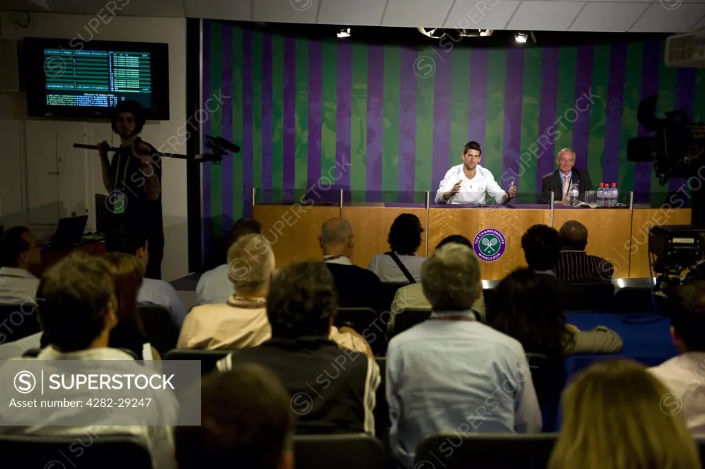 England, London, Wimbledon. Novak Djokovic (SRB) talks to the media in the champions press conference after victory at the 2011 Wimbledon Tennis Championships.