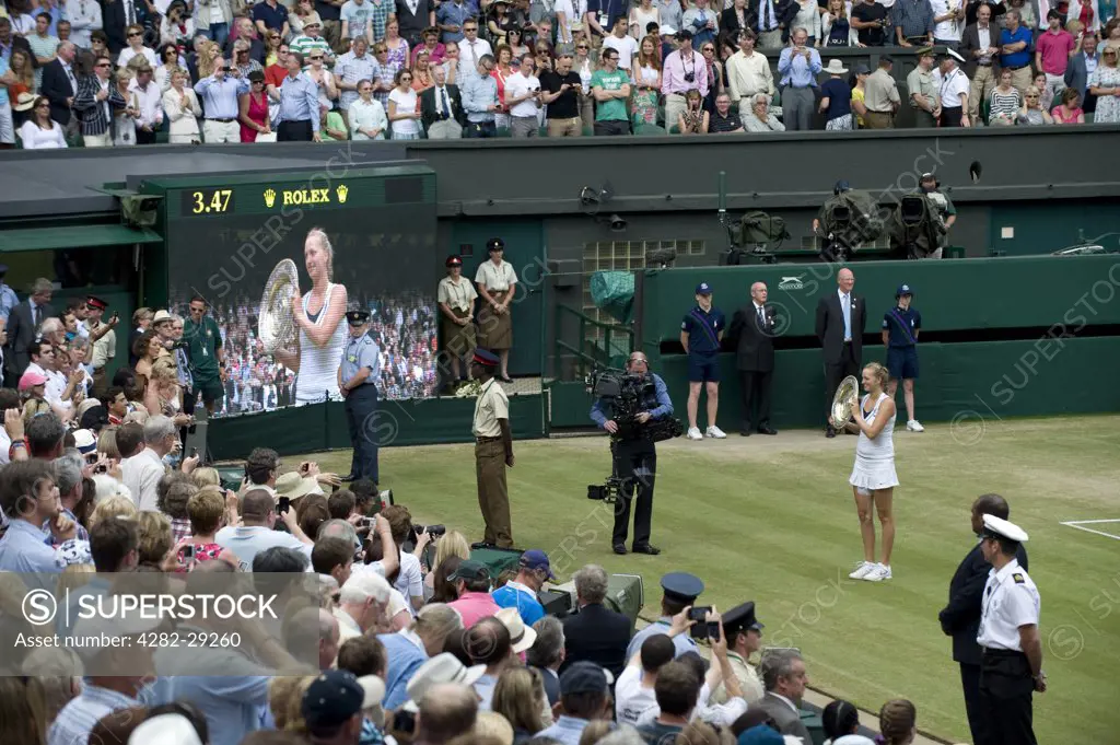 England, London, Wimbledon. Petra Kvitova (CZE) showing spectators the Venus Rosewater Dish on centre court after victory in the Ladies' singles final at the 2011 Wimbledon Tennis Championships.