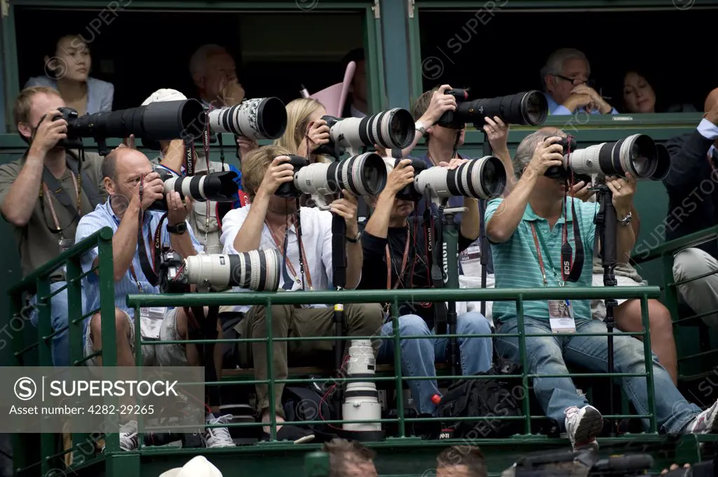 England, London, Wimbledon. Photographers at work on Centre Court during the Wimbledon Tennis Championships 2011.