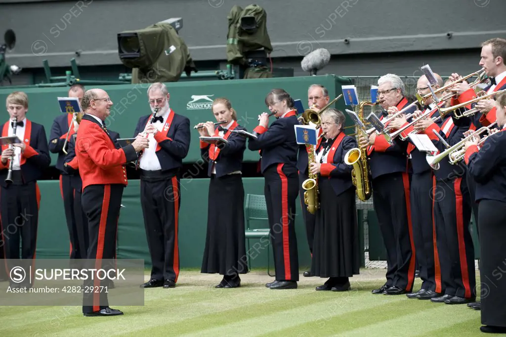 England, London, Wimbledon. The Central Band of the Royal British Legion play on Centre Court at the 2011 Wimbledon Tennis Championships.
