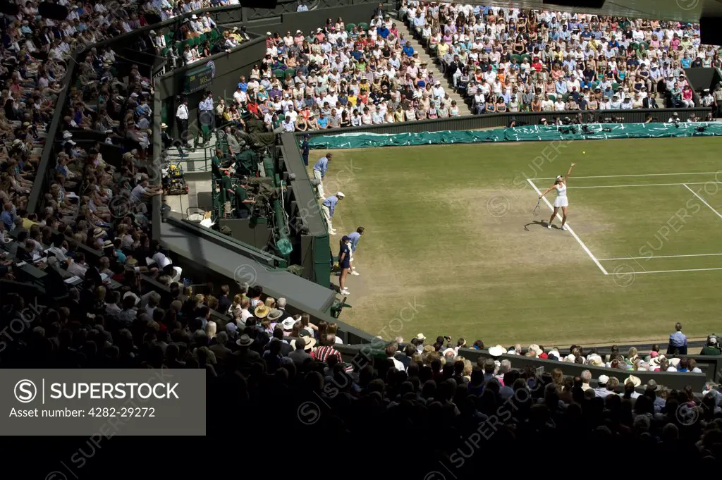 England, London, Wimbledon. Maria Sharapova serving on Centre Court in the Ladies Singles Final against Petra Kvitova at the 2011 Wimbledon Tennis Championships.