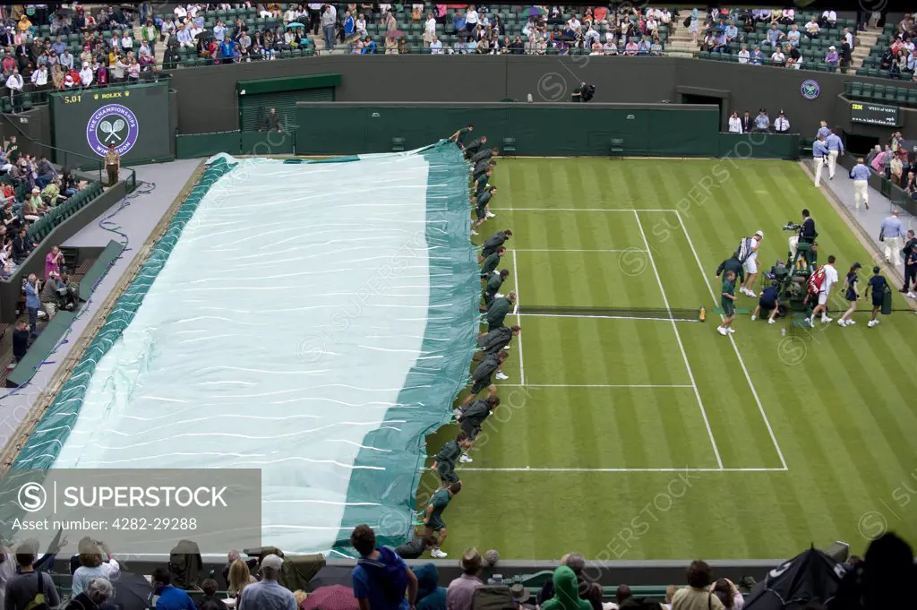 England, London, Wimbledon. Court 1 is covered as the rain starts to fall during a match at the 2011 Wimbledon Tennis Championships.