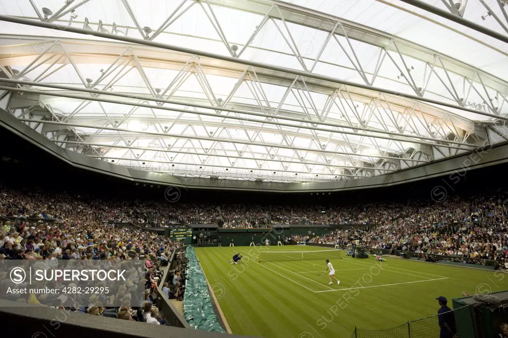 England, London, Wimbledon. A match between Francesca Schiavone and Jelena Dokic under the roof on Centre Court at the 2011 Wimbledon Tennis Championships.